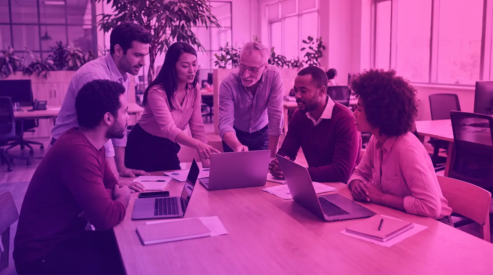 A diverse group of coworkers collaborates in a modern office
