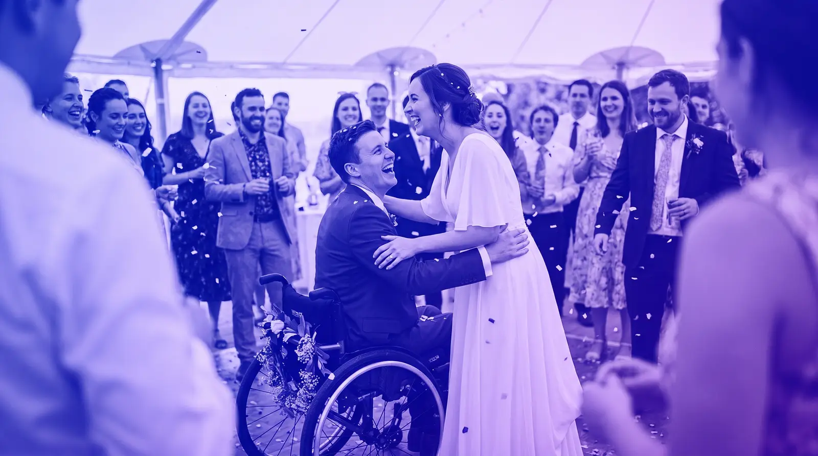 A couple, one using a wheelchair, celebrates at an accessible wedding venue