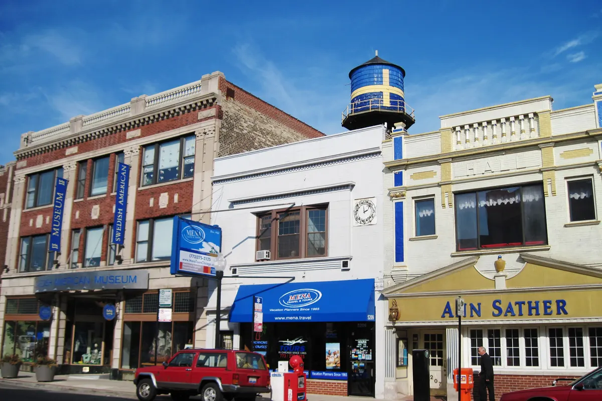 Storefronts on Clark Street in Andersonville, with the Swedish-flag water tower of the Swedish American Museum
