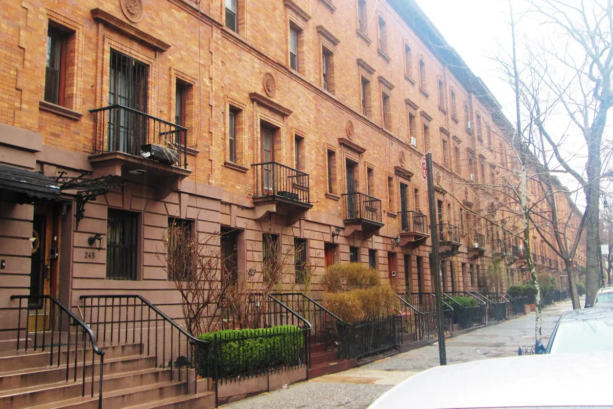 A row of yellow-brick townhouses on West 139th Street in Harlem's Strivers' Row