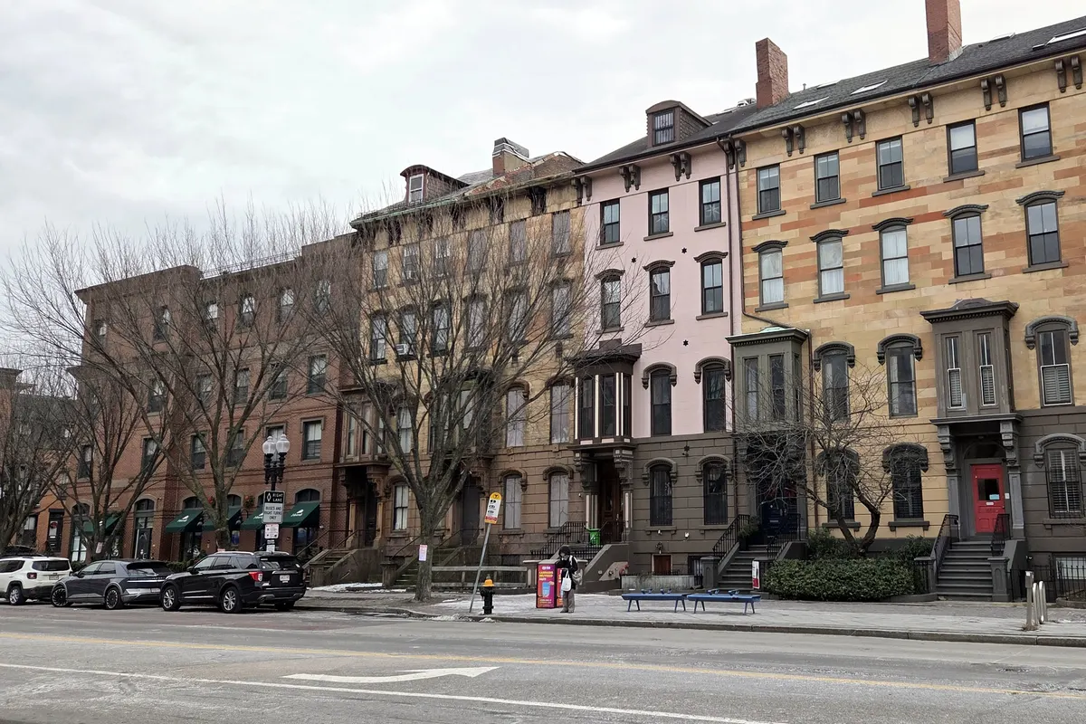 A row of Victorian brick and brownstone rowhouses on Washington Street in Boston's South End