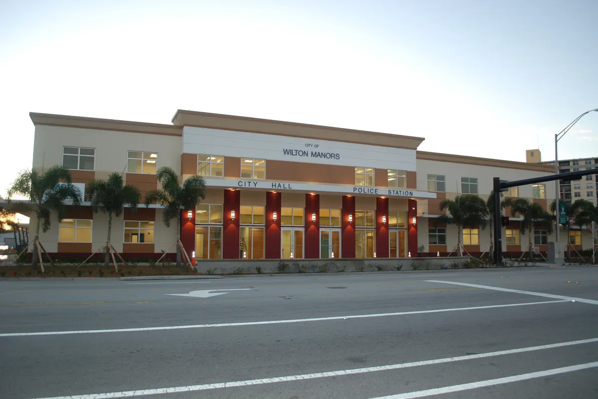 Wilton Manors City Hall, a two-story building with palm trees, on Wilton Drive