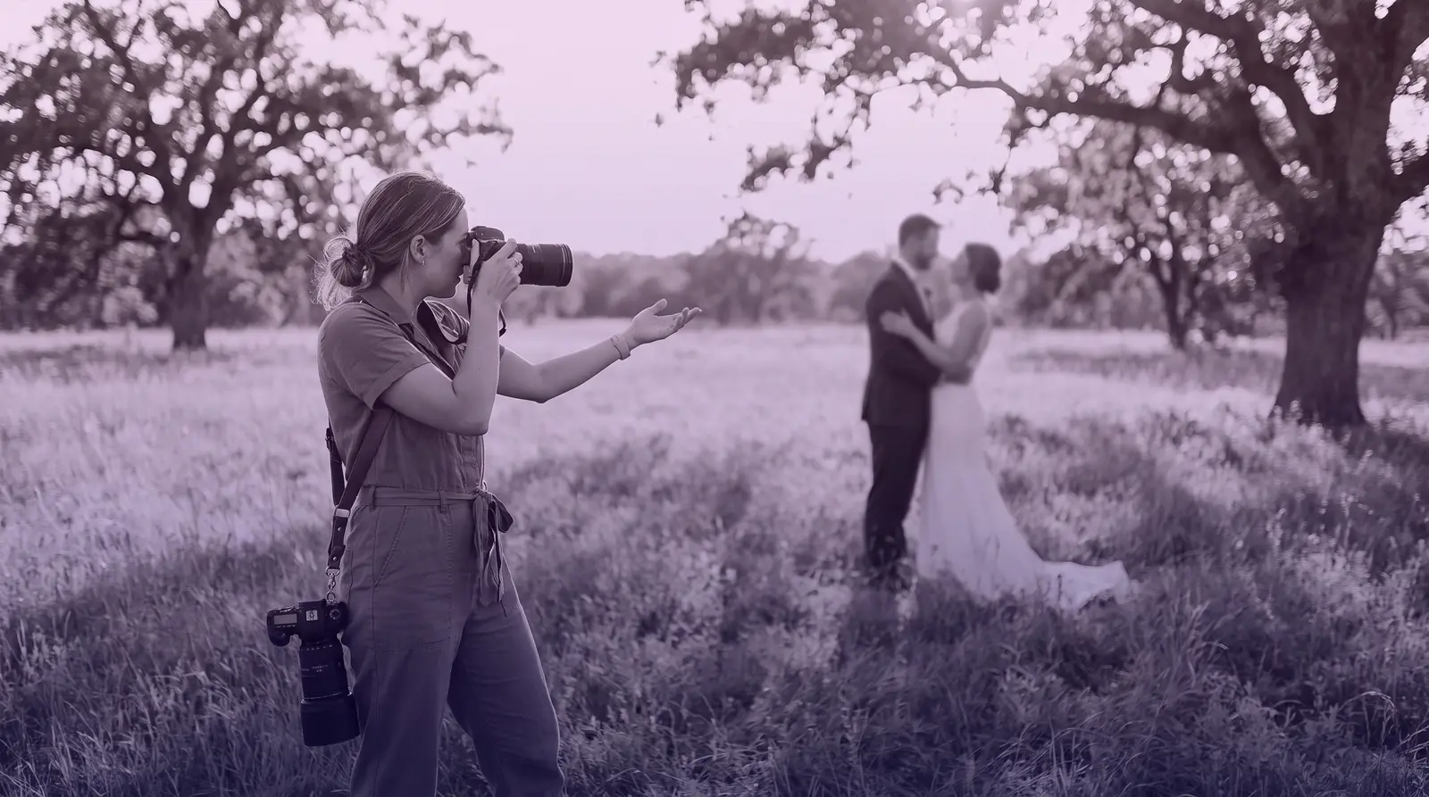 A woman photographer directs a couple during a wedding shoot