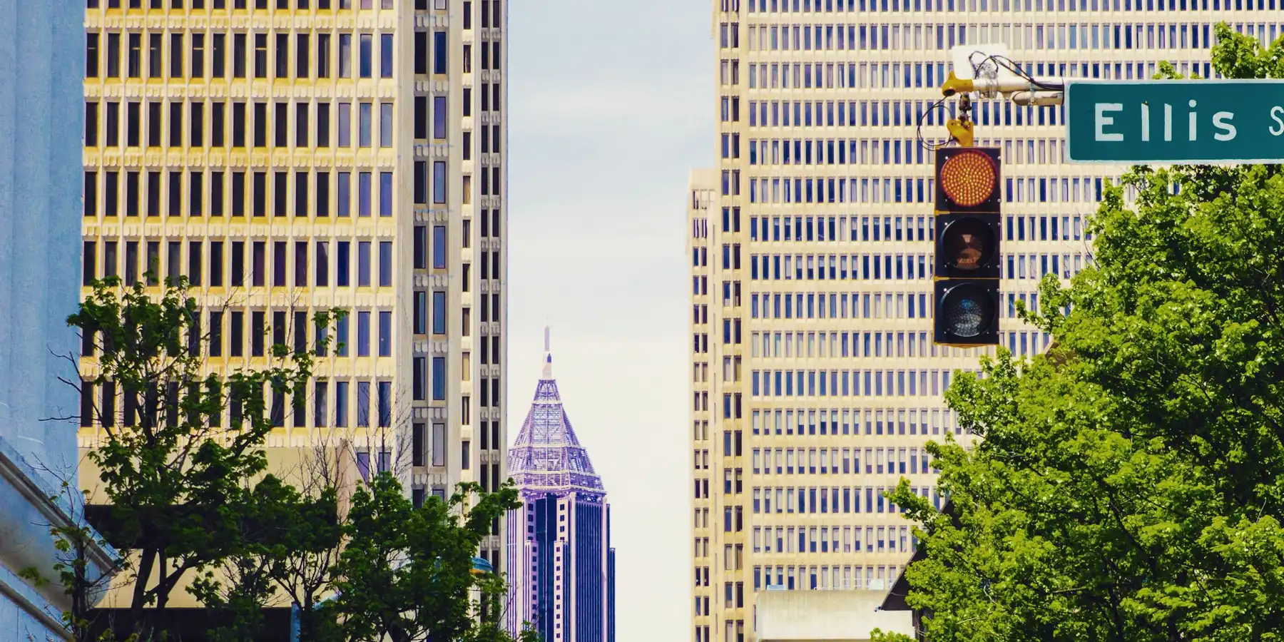 A downtown Atlanta street with Bank of America Plaza rising in the distance