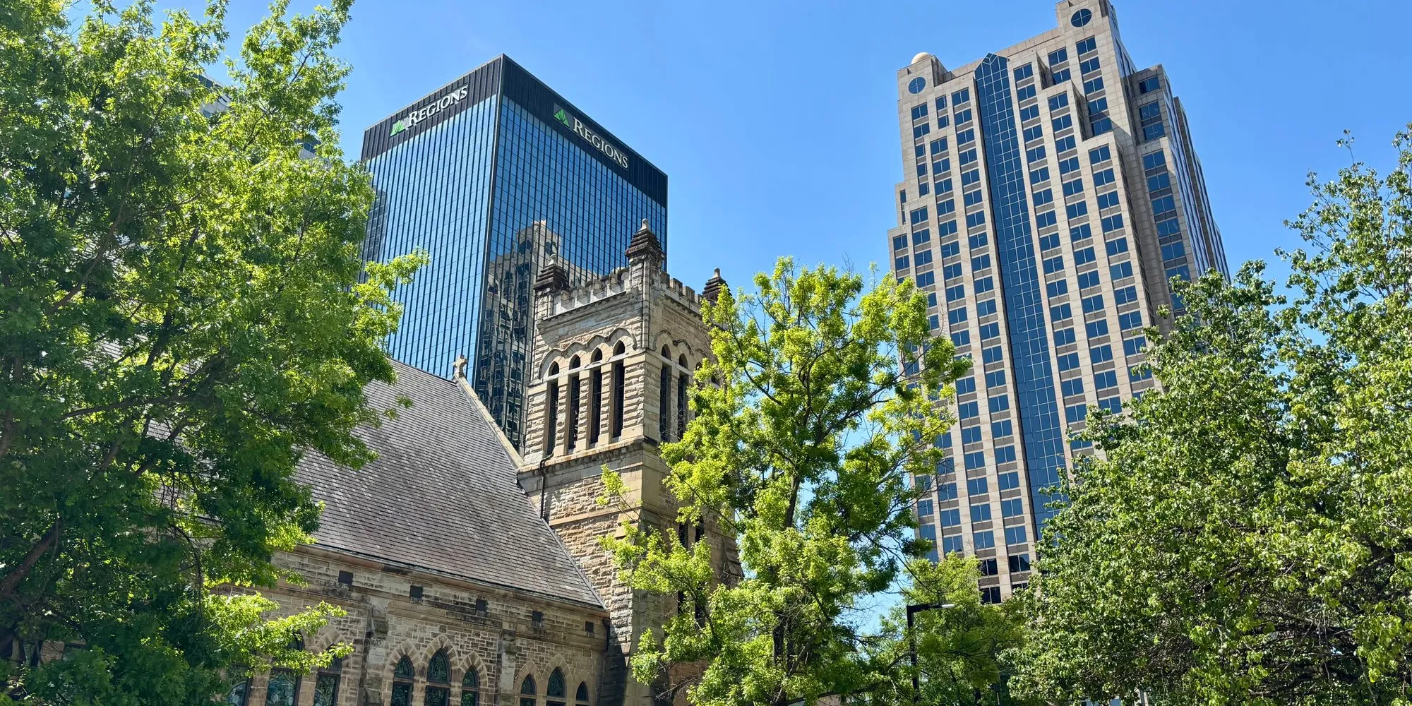 A historic stone church below the Regions tower in downtown Birmingham