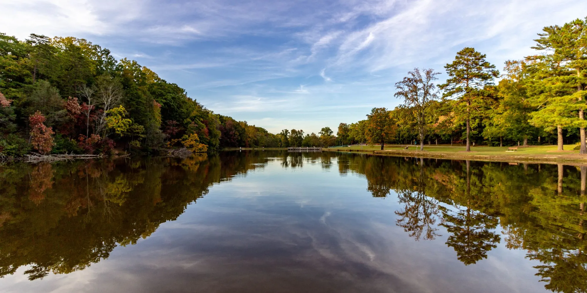 Autumn trees reflected in a lake in a Greensboro park