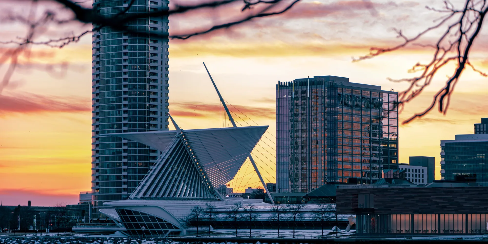 The Milwaukee skyline at sunset behind the Art Museum's white wings