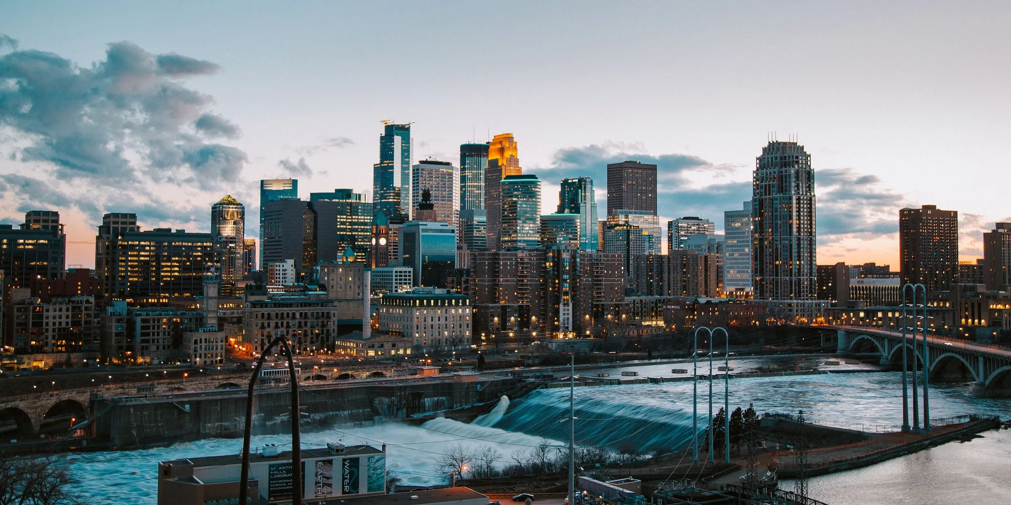 The Minneapolis skyline at dusk above St. Anthony Falls on the Mississippi