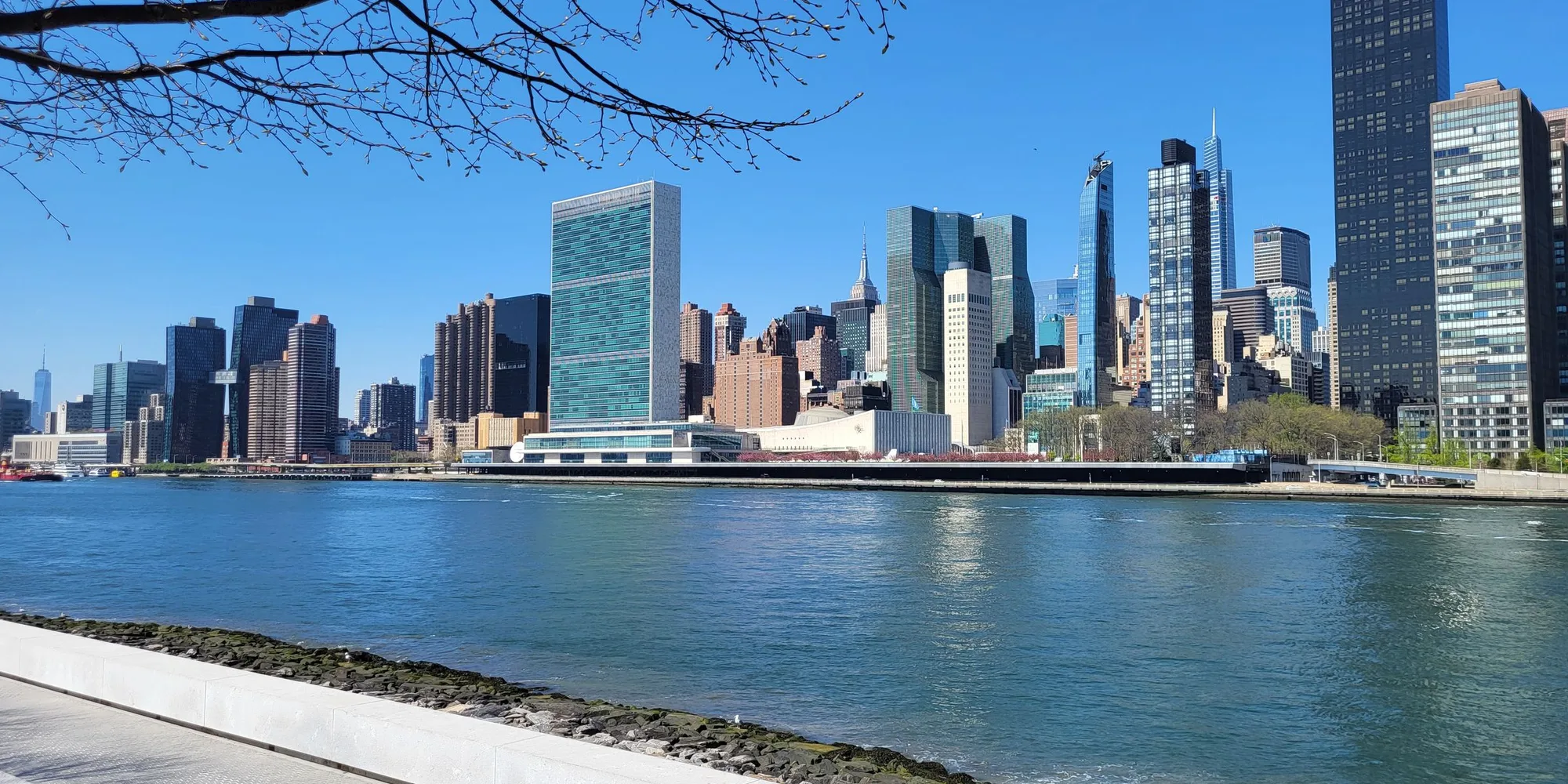 The Midtown Manhattan skyline seen across the East River, with the United Nations Secretariat building at the center
