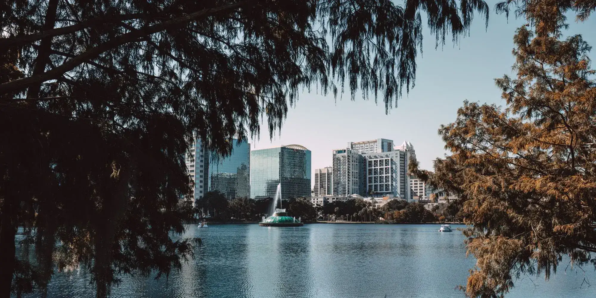 Downtown Orlando seen across Lake Eola with the park fountain in the water