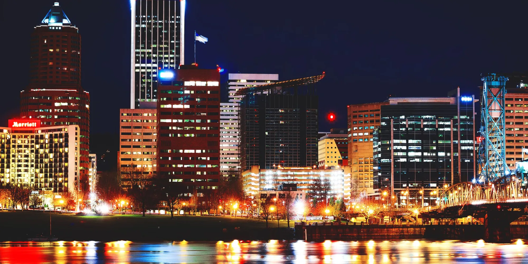 The Portland skyline reflected in the Willamette at night