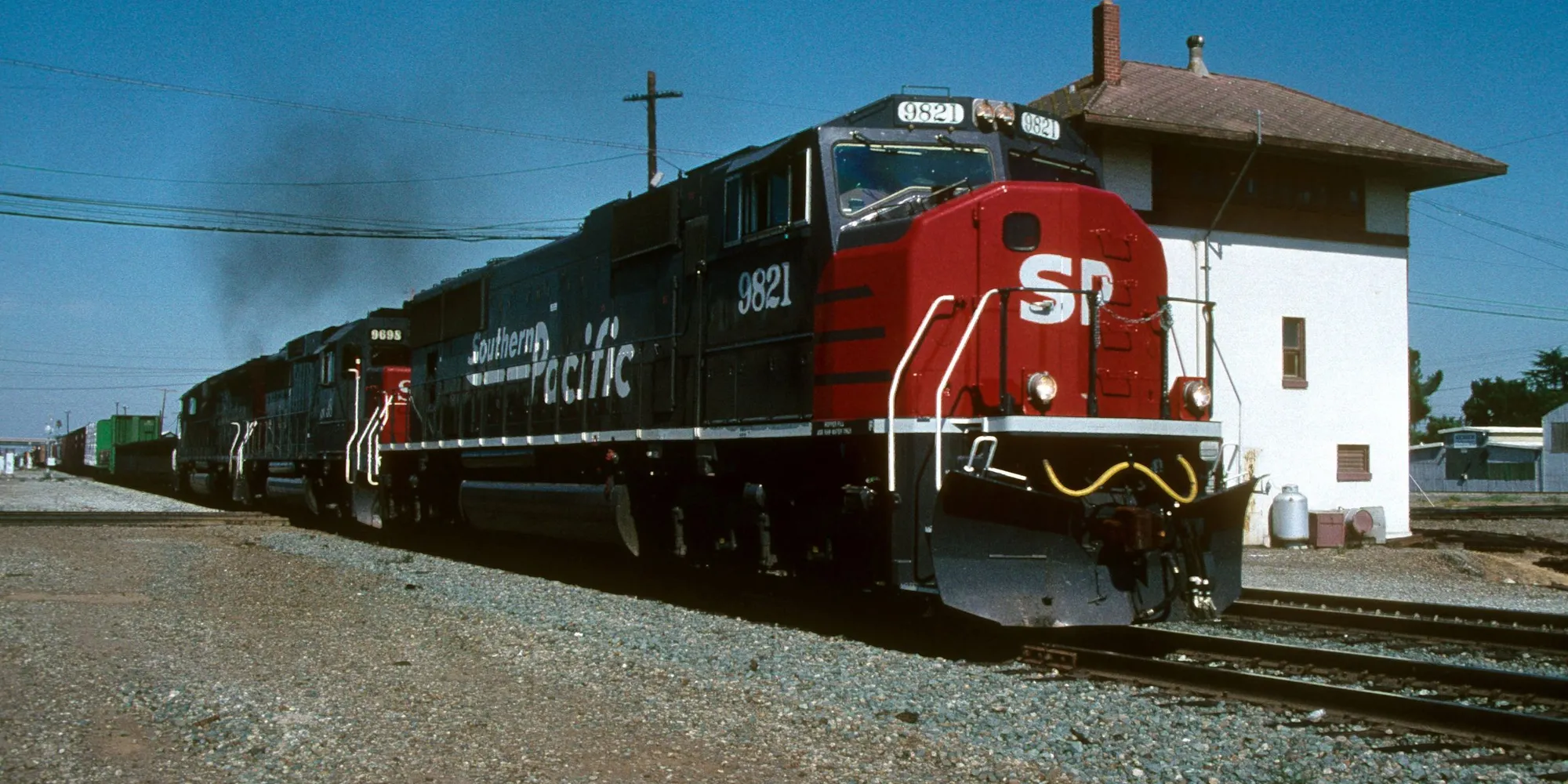 A Southern Pacific freight train passing a depot in Stockton, California